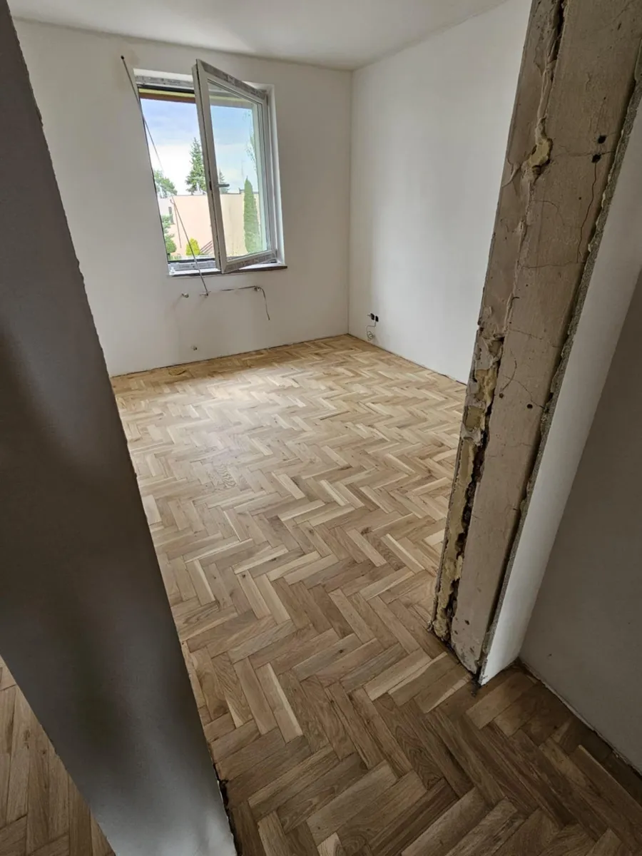A herringbone parquet after sanding, seen from the door