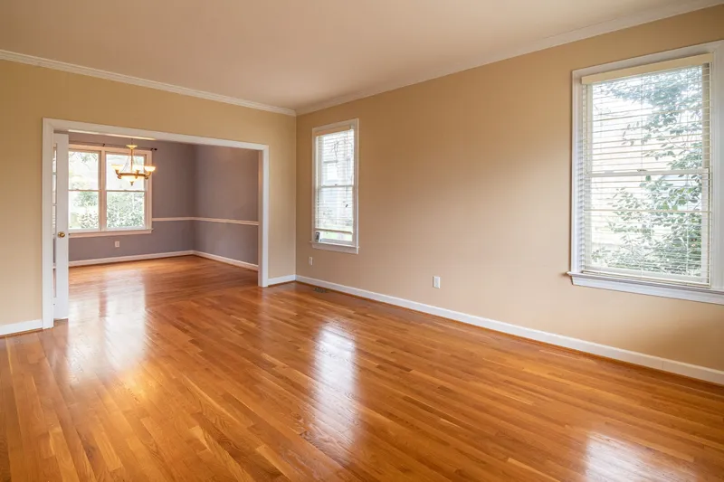 A renewed plank floor with a warm sheen in an empty, bright room