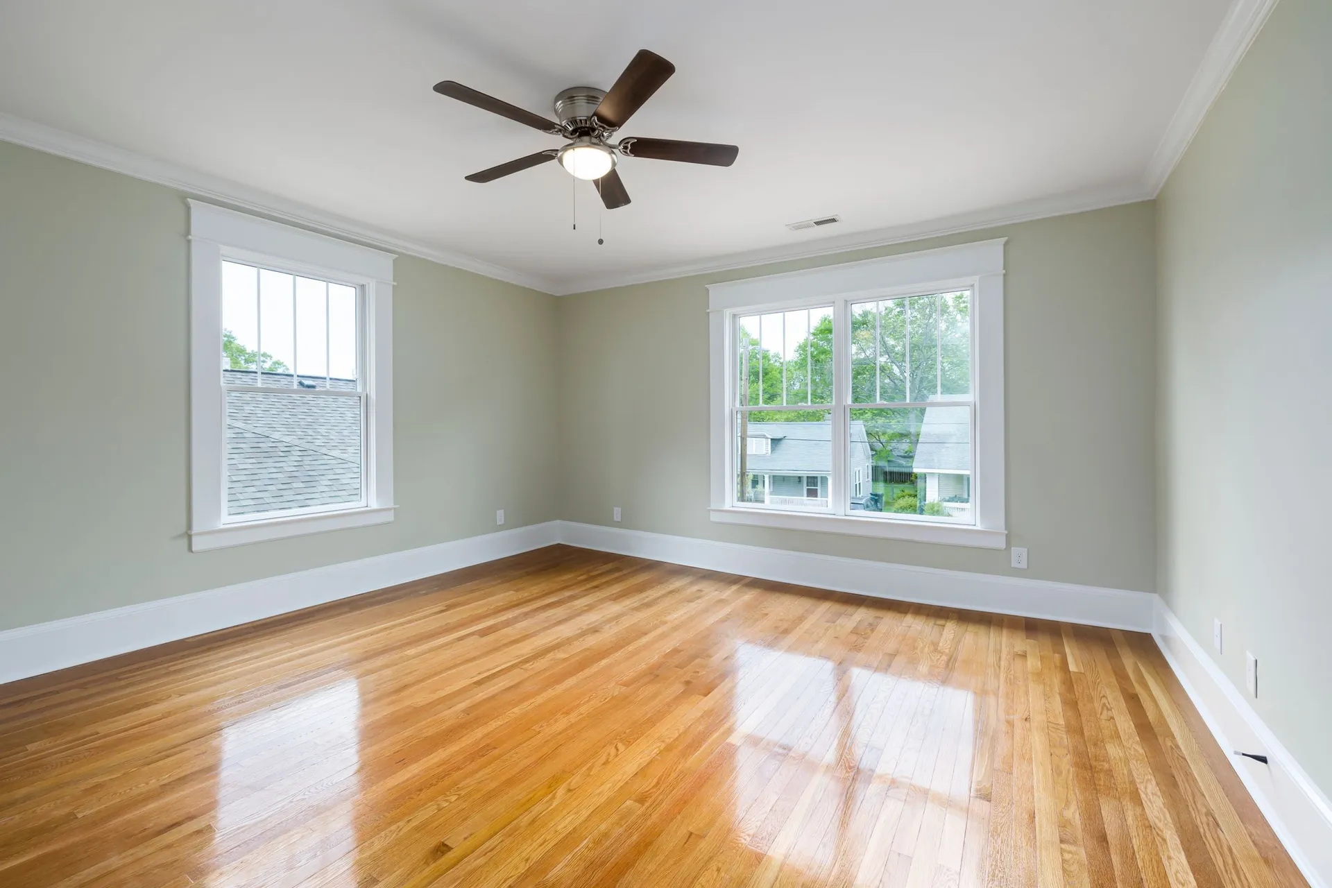 A lacquered floor reflecting the windows in the sun