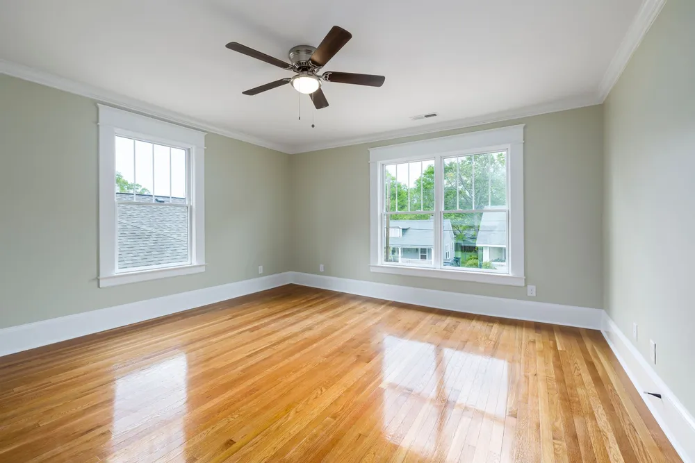 A lacquered floor reflecting the windows in the sun