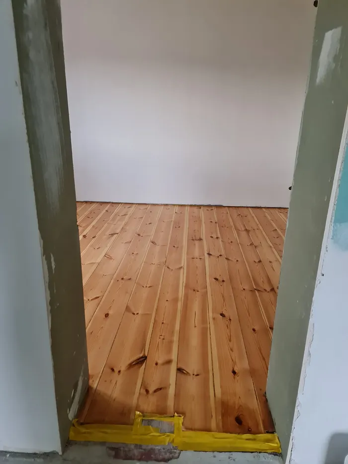 Sanded pine boards seen through a doorway
