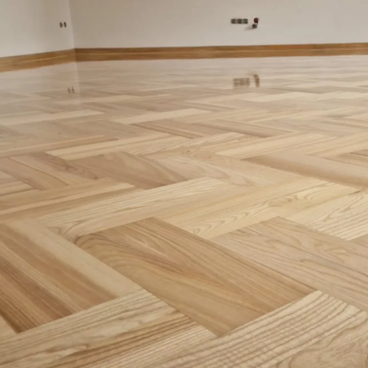 A light herringbone parquet after sanding and lacquering, close-up
